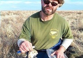 A researcher processes an Ord’s kangaroo rat at a trapping station.