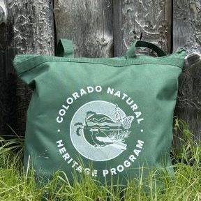 photo of bag in grass with Colorado Natural Heritage Program logo displayed on front on bag
